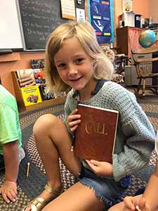 Kids holding the book The Call, by Wendy K. Ulmer